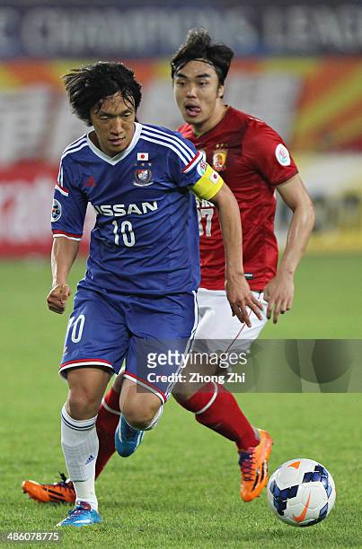 Nakamura Shunsuke of Yokohama F. Marinos in action with Zhao Xuri of Guangzhou Evergrande during the AFC Asian Champions League match between...