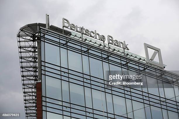 Logo stands on display outside the regional headquarters of Deutsche Bank AG in Moscow, Russia, on Tuesday, April 22, 2014. Bankers collected $108...
