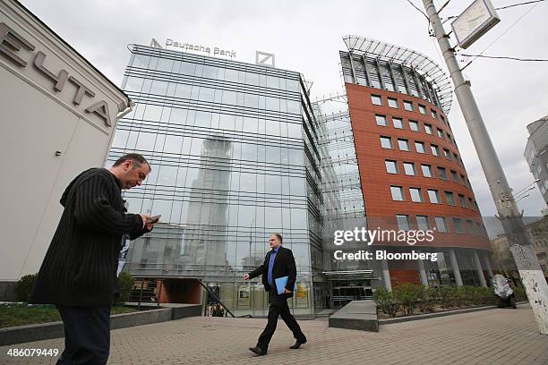 Pedestrians pass the regional headquarters of Deutsche Bank AG in Moscow, Russia, on Tuesday, April 22, 2014. Bankers collected $108 million on...