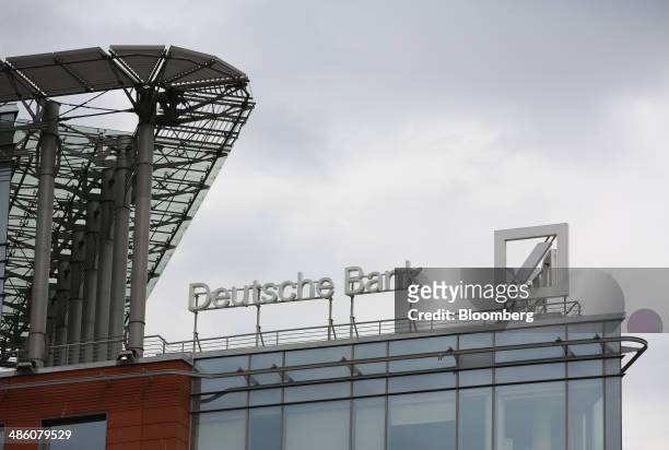 Logo stands on display outside the regional headquarters of Deutsche Bank AG in Moscow, Russia, on Tuesday, April 22, 2014. Bankers collected $108...