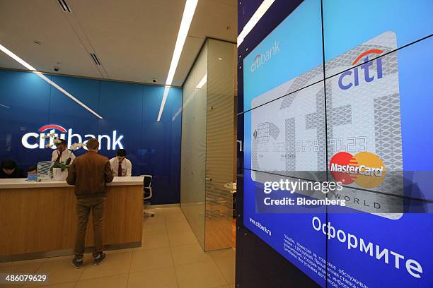 Digital advertisement for the Mastercard Inc. Payment service with a Citi banking card sits on a screen inside a Citibank bank branch operated by...