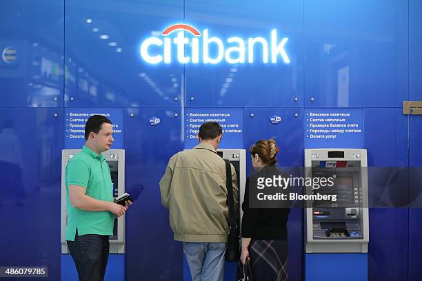 Customers use automated teller machines inside a Citibank bank branch operated by Citigroup Inc. In Moscow, Russia, on Tuesday, April 22, 2014....