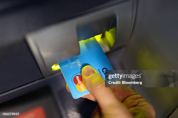 Mastercard Inc. Logo sits on a Citi banking card placed in an automated teller machine inside a Citibank bank branch operated by Citigroup Inc. In...