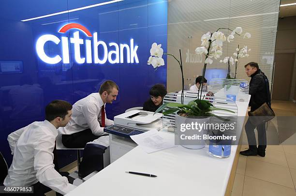 Employees work behind the service desk inside a Citibank bank branch operated by Citigroup Inc. In Moscow, Russia, on Tuesday, April 22, 2014....