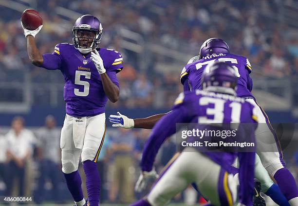 Teddy Bridgewater of the Minnesota Vikings completes a pass to Jerick McKinnon of the Minnesota Vikings under pressure from Jeremy Mincey of the...