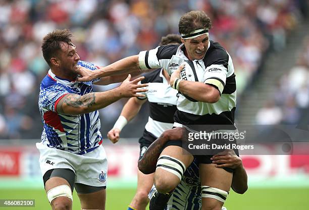 Luke Jones of the Barbarians holds off Jack Lam during the Rugby Union match between the Barbarians and Samoa at the Olympic Stadium on August 29,...