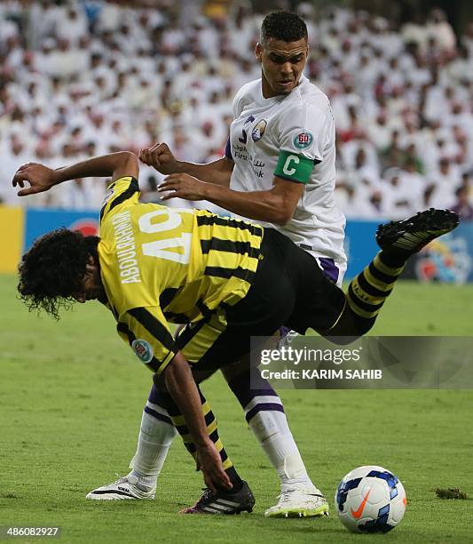 S Al-Ain captain Ismail Ahmed fights for the ball against Saudi's Al-Ittihad player Abdulrahman Al-Ghamdi during their AFC Champions League Group C...