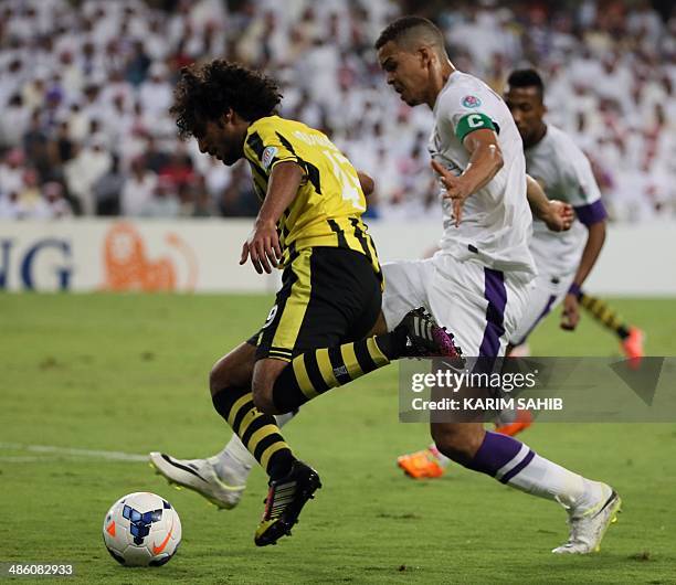 S Al-Ain captain Ismail Ahmed fights for the ball against Saudi's Al-Ittihad player Abdulrahman Al-Ghamdi during their AFC Champions League Group C...