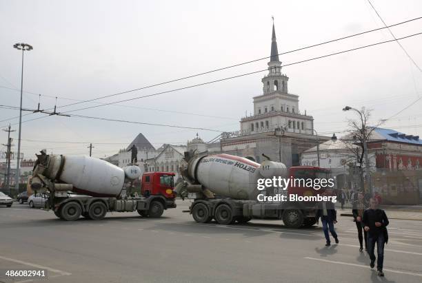 Two cement mixing trucks pass Kazansky railway station, center, in Moscow, Russia, on Tuesday, April 22, 2014. Bankers collected $108 million on...