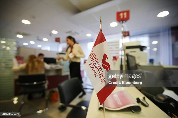 Branded miniature flag stands on a service desk inside a Credit Bank of Moscow bank branch in Moscow, Russia, on Tuesday, April 22, 2014. Bankers...