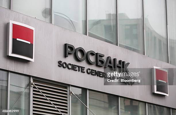 Societe Generale Group logo stands on display outside an OAO Rosbank bank branch in Moscow, Russia, on Tuesday, April 22, 2014. Bankers collected...