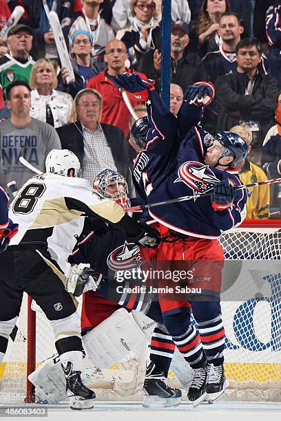 Nikita Nikitin and Matt Calvert of the Columbus Blue Jackets jump to knock down a loose puck during the third period in Game Three of the First Round...