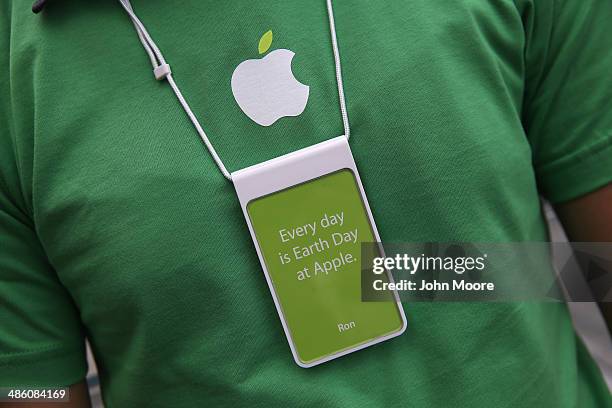 An Apple employee waits to greet customers at Apple's Fifth Avenue store on Earth Day in Midtown Manhattan on April 22, 2014 in New York City. The...
