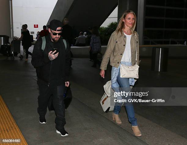 Cameron Diaz and Benji Madden are seen at LAX. On August 31, 2015 in Los Angeles, California.