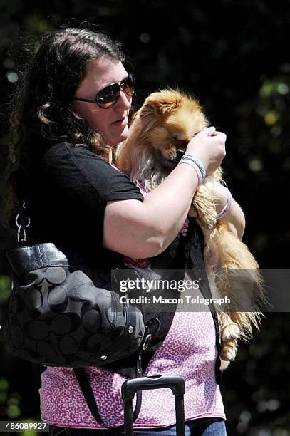 Lauren Teresa Giddings' 1st cousin Casie Giddings holds Lauren's dog Butterbean at a picnic held held by supporters in Washington Park Stephen Monday...