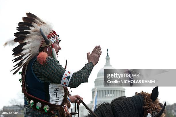 Native American tribal leader sits on his horse in front of the US Capitol in Washington on April 22, 2014 as the Cowboy and Indian Alliance protest...