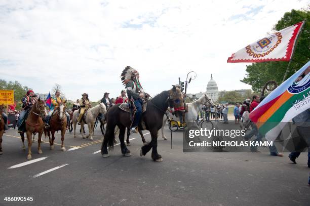 Native Americans, farmers and ranchers march in front of the US Capitol in Washington on April 22, 2014 as the Cowboy and Indian Alliance protest the...