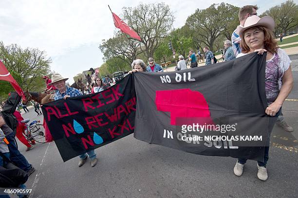 Members of the Cowboy and Indian Alliance hold signs in front of the US Capitol in Washington on April 22, 2014 as they protest the proposed Keystone...