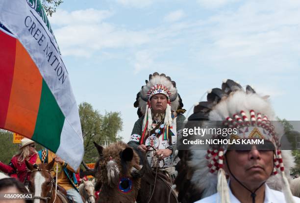 Members of the Cowboy and Indian Alliance march in Washington on April 22, 2014 as they protest the proposed Keystone XL pipeline, part of "Reject...