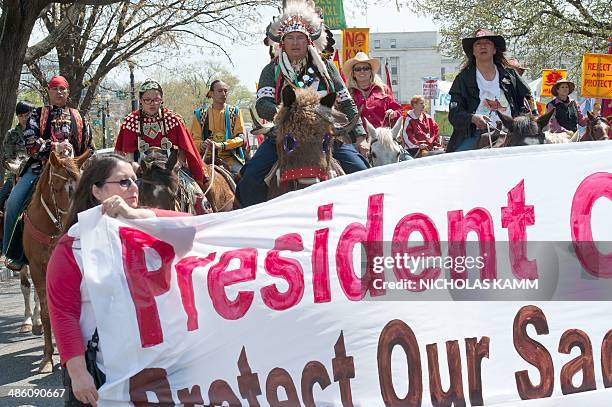 Members of the Cowboy and Indian Alliance march in Washington on April 22, 2014 as they protest the proposed Keystone XL pipeline, part of "Reject...