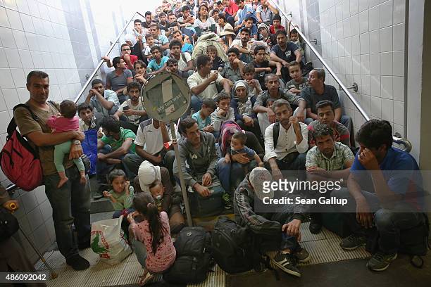 Some of approximately 190 migrants who arrived on a train from Budapest and were detained by German police wait to be initially registered by the...