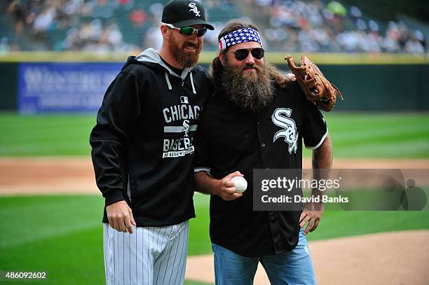 Willie Robertson star of Duck Dynasty talks with Adam LaRoche of the Chicago White Sox after throwing out the ceremonial first pitch before theme...