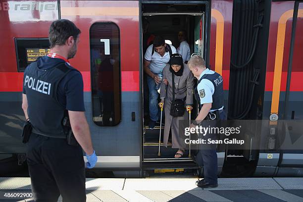 Police detain some of a total of 190 migrants from a train that arrived from Budapest at Rosenheim railway station on August 31, 2015 in Rosenheim,...