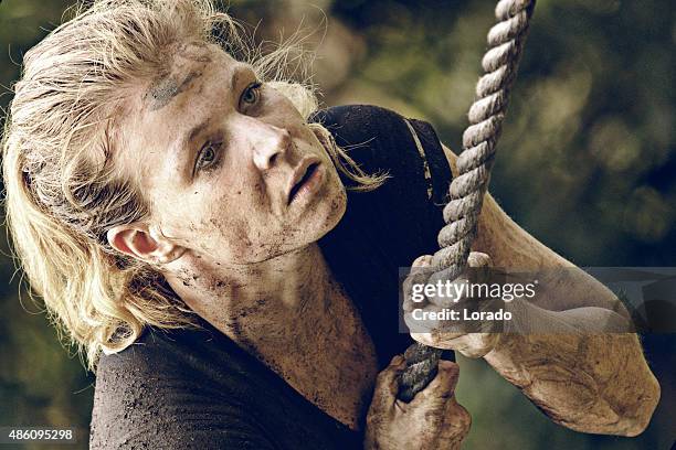 woman climbing rope during obstacle run - hinderbana bildbanksfoton och bilder