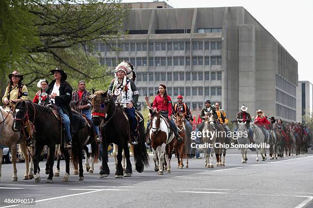 Members of the Cowboy and Indian Alliance, including Native Americans, farmers and ranchers from across the United States, ride horseback down...
