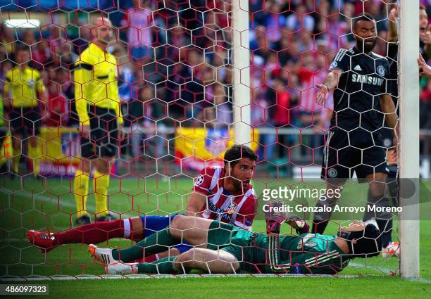 Petr Cech of Chelsea lies injured after clashed with Raul Garcia of Club Atletico de Madrid during the UEFA Champions League Semi Final first leg...