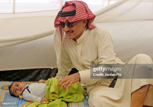 Saudi Prince Alwaleed bin Talal visits the tent of Syrian refugees who came from Idlib during his visit to Zaatari camp for Syrian refugees on April...