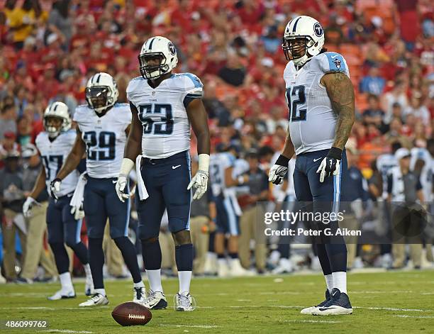 Defenders Ropati Pitoitua, Deiontriz Mount and Perrish Cox of the Tennessee Titans look on against the Kansas City Chiefs during the first half of a...