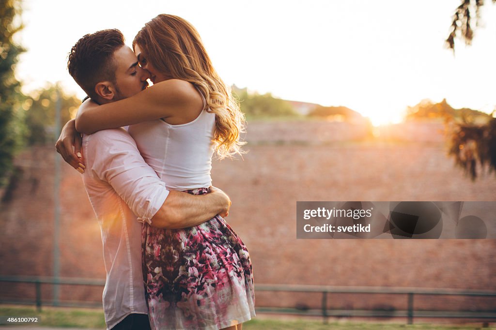 Young couple walking in park.