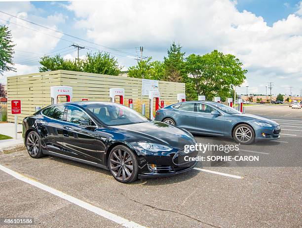 two electric cars in charging. - supercharged engine stock pictures, royalty-free photos & images