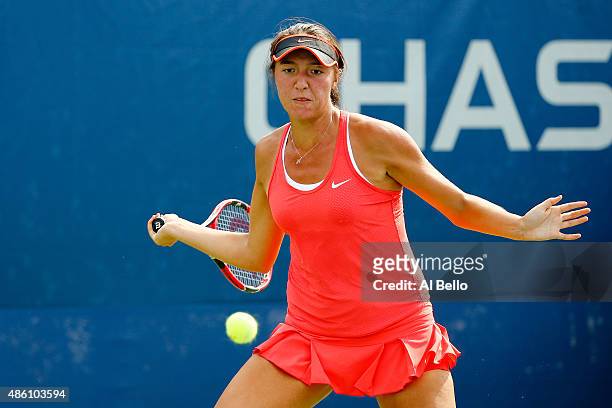 Samantha Crawford of the United States returns a shot against Irina Falconi of the United States during her Women's Singles First Round match on Day...