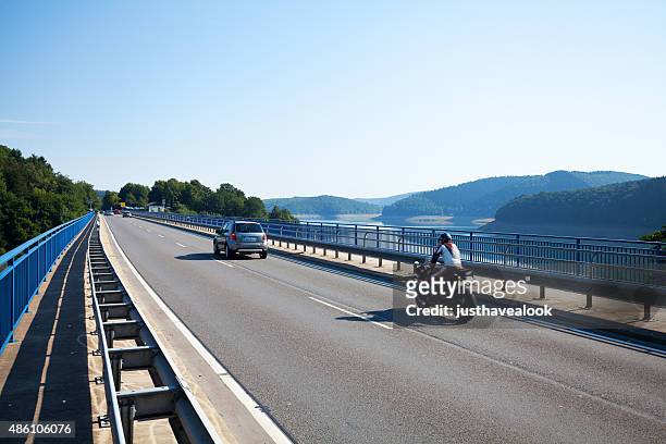 road l 512 and bridge at lake biggesee - car and motorcycle on mountain road stock pictures, royalty-free photos & images