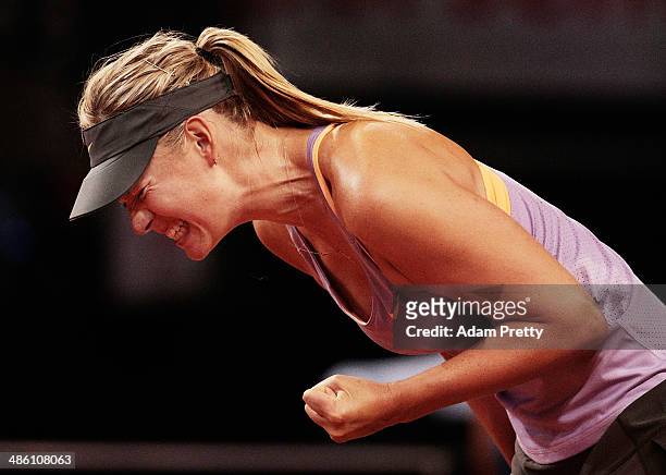 Maria Sharapova of Russia celebrates a point during her first round match against Lucie Safarova of the Czech Republic during day 2 of the Porsche...