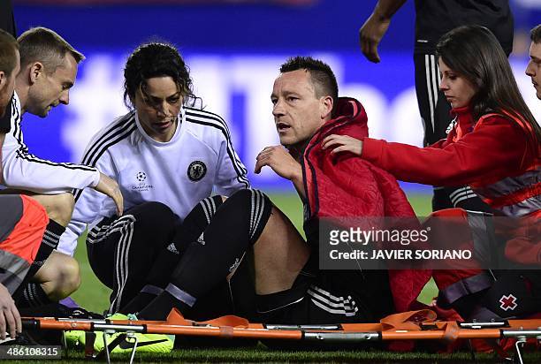 Chelsea's defender John Terry sits on a stretcher accompanied by team doctor Eva Carneiro during the UEFA Champions League first leg semi-final...