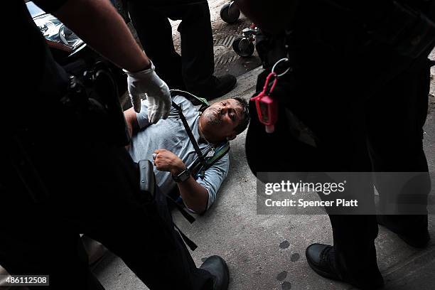 Passed out man lies on a sidewalk in an area which has witnessed an explosion in the use of K2 or 'Spice', a synthetic marijuana drug in East Harlem...