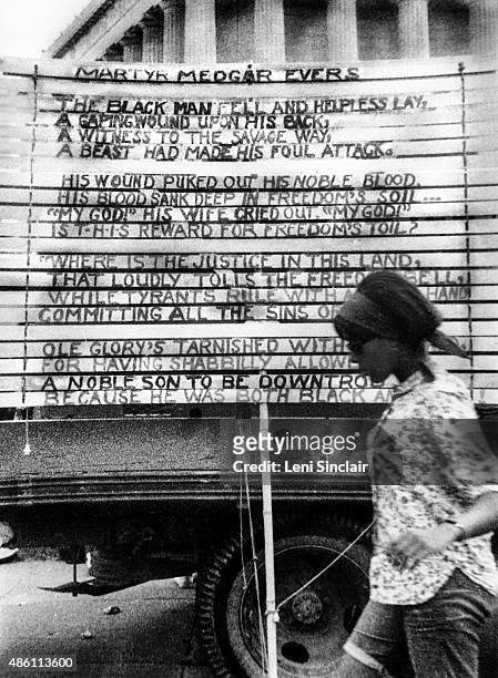 Woman walks by a Poem for Medgar Evers written on the side of a truck at the March on Washington, August 28 in Washington, D.C.