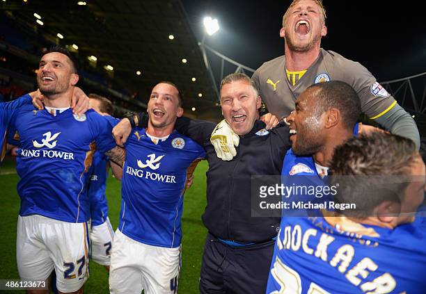 Goalkeeper Kasper Schmeichel of Leicester City jumps on the shoulders of Nigel Pearson, manager of Leicester City as he celebrates winning the...
