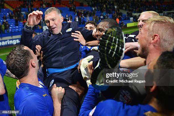 Nigel Pearson, manager of Leicester City is held aloft by his players as they celebrate winning the Championship after the Sky Bet Championship match...