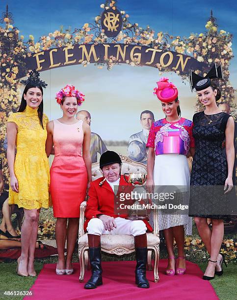 John Patterson, FlemingtonÕs Clerk of the Course for more than 50 years poses with the Melbourne Cup alongside models during the Melbourne Cup...