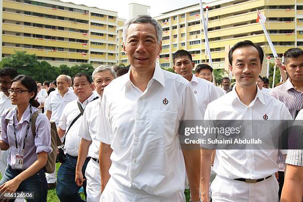 Prime Minister and People's Action Party Secretary General, Lee Hsien Loong walks to the nomination with party members at Raffles Institution on...