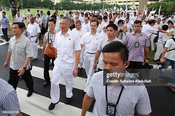 Prime Minister and People's Action Party Secretary General, Lee Hsien Loong walks to the nomination centre with party members at Raffles Institution...