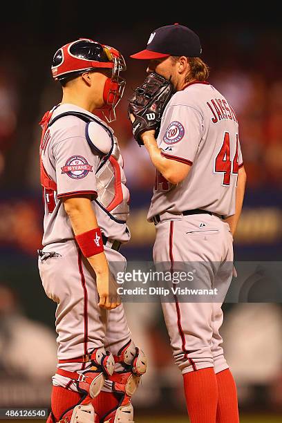 Jose Lobaton and Casey Janssen of the Washington Nationals meet on the pitchers mound in the seventh inning against the St. Louis Cardinals at Busch...