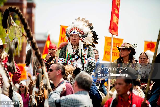 Shane Red Hawk of the Sicangu Lakota band of the Rosebud Sioux, center left, rides a horse during a protest against the Keystone XL pipeline with...