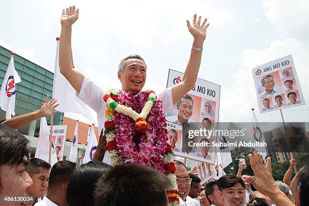 Prime Minister and People's Action Party Secretary General, Lee Hsien Loong reacts with party supporters after nomination is closed at Raffles...