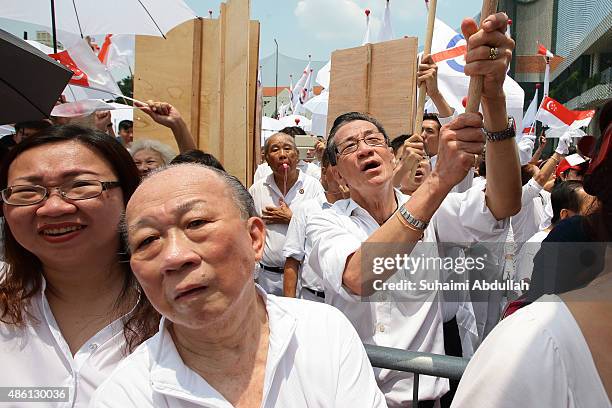 People's Action Party supporters react to their candidate speech after nomination is closed at Raffles Institution on September 1, 2015 in Singapore....