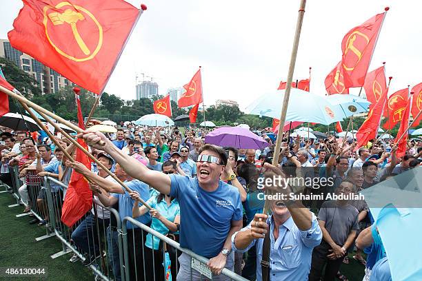 Worker's Party supporters react to their candidate speech after nomination is closed at Raffles Institution on September 1, 2015 in Singapore....